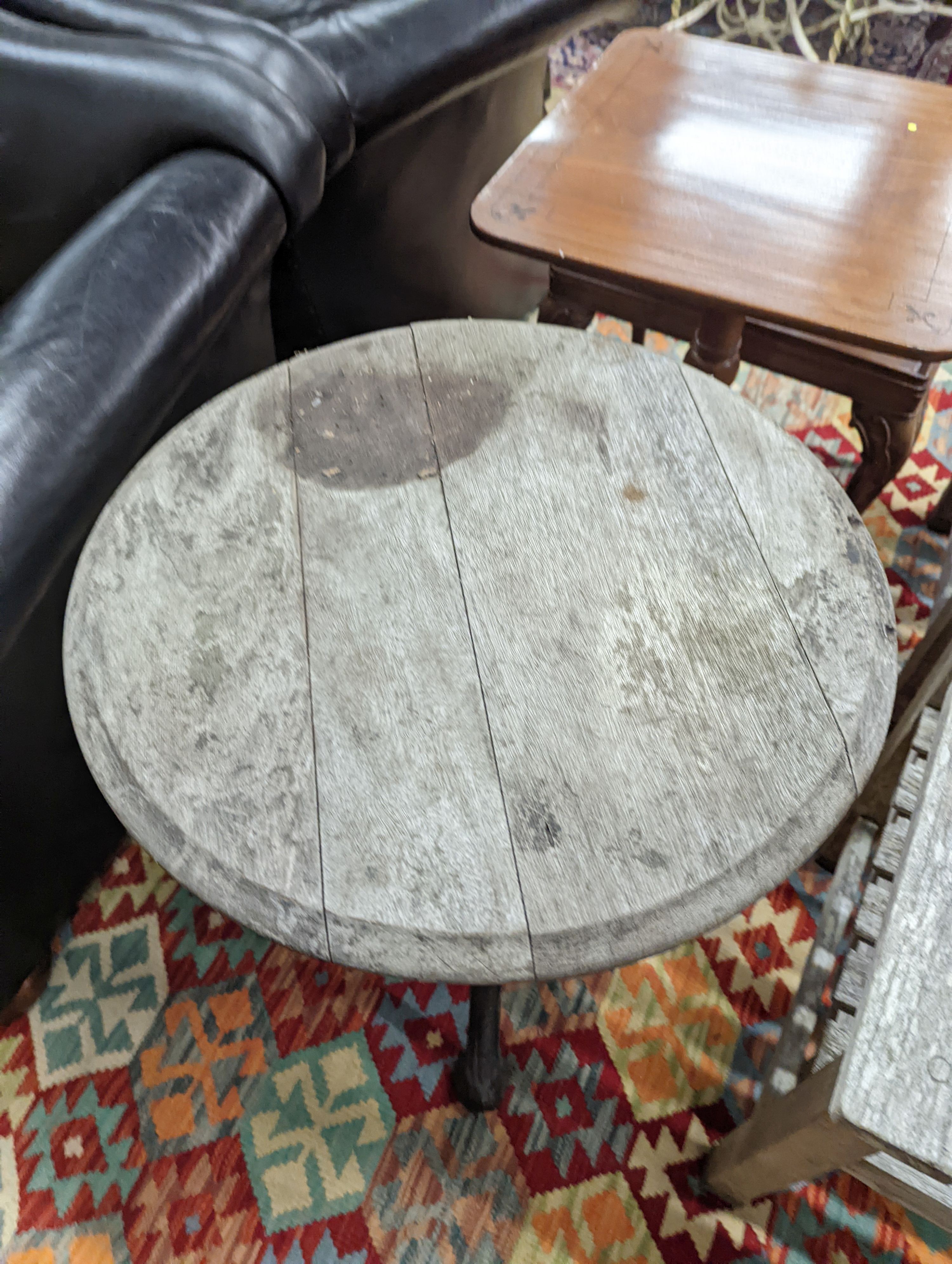 A Victorian cast iron Britannia table with circular weathered wood top, diameter 58cm, height 69cm